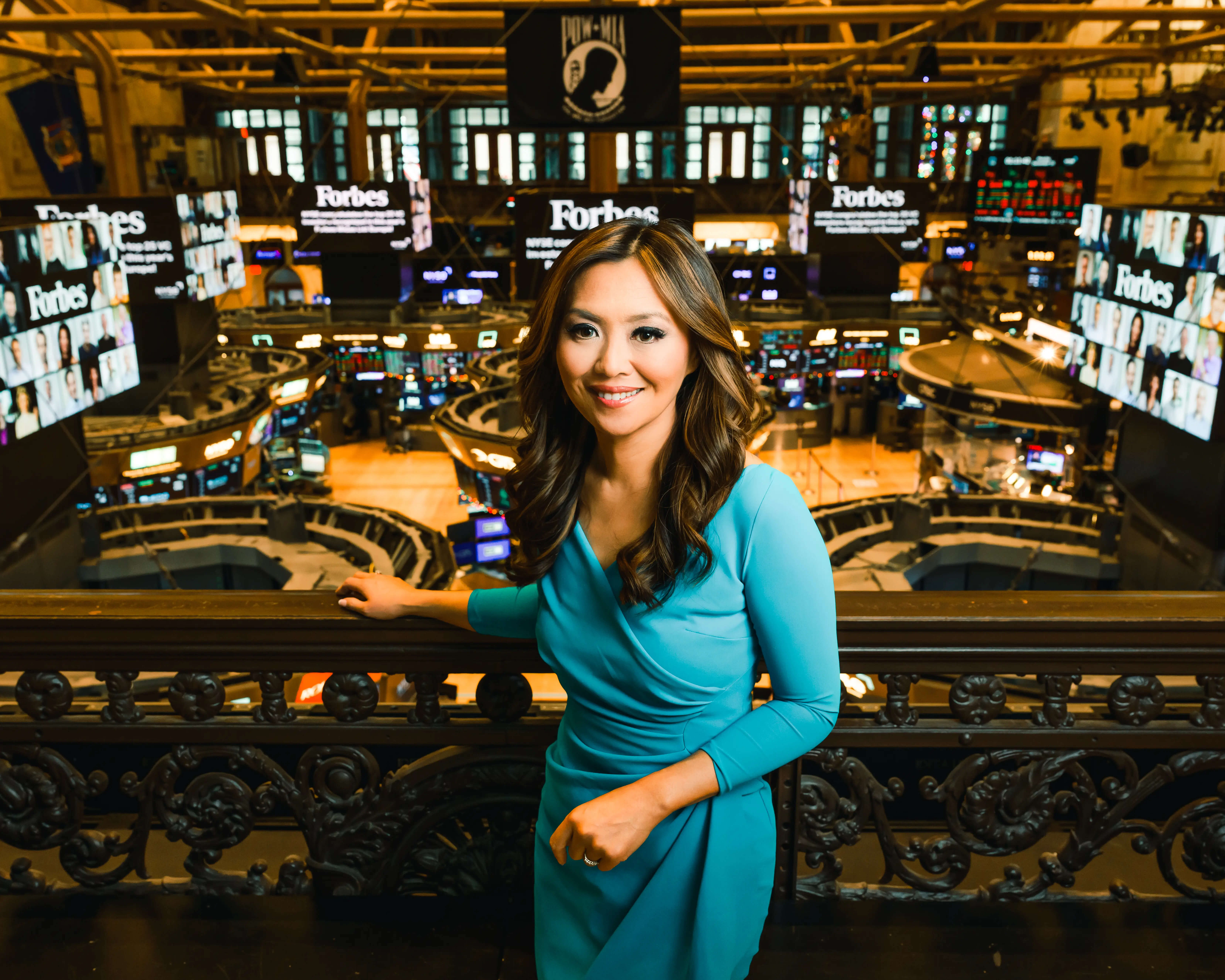Remy Blaire standing at the New York Stock Exchange, ready to report on global financial markets
